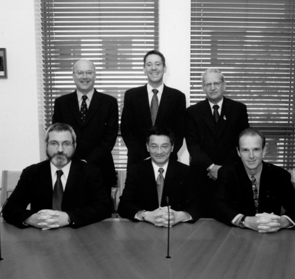Regulations and Ordinances Committee, 12 September 2002. Standing L-R: Senators George Brandis, Brett Mason and Geoffrey Buckland. Seated L-R: Senators Andrew Bartlett, Tsebin Tchen and Joseph Ludwig.