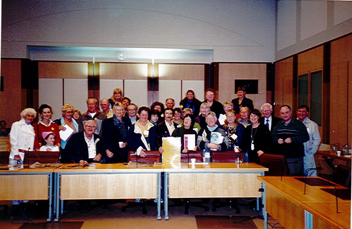Care leavers at a press conference where they were able to ask questions of senators following the tabling of the Forgotten Australians report, Parliament House, 30 August 2004. CLAN co-founder, Dr Joanna Penglase holds a copy of the report. Image courtesy of Leonie Sheedy, CLAN.