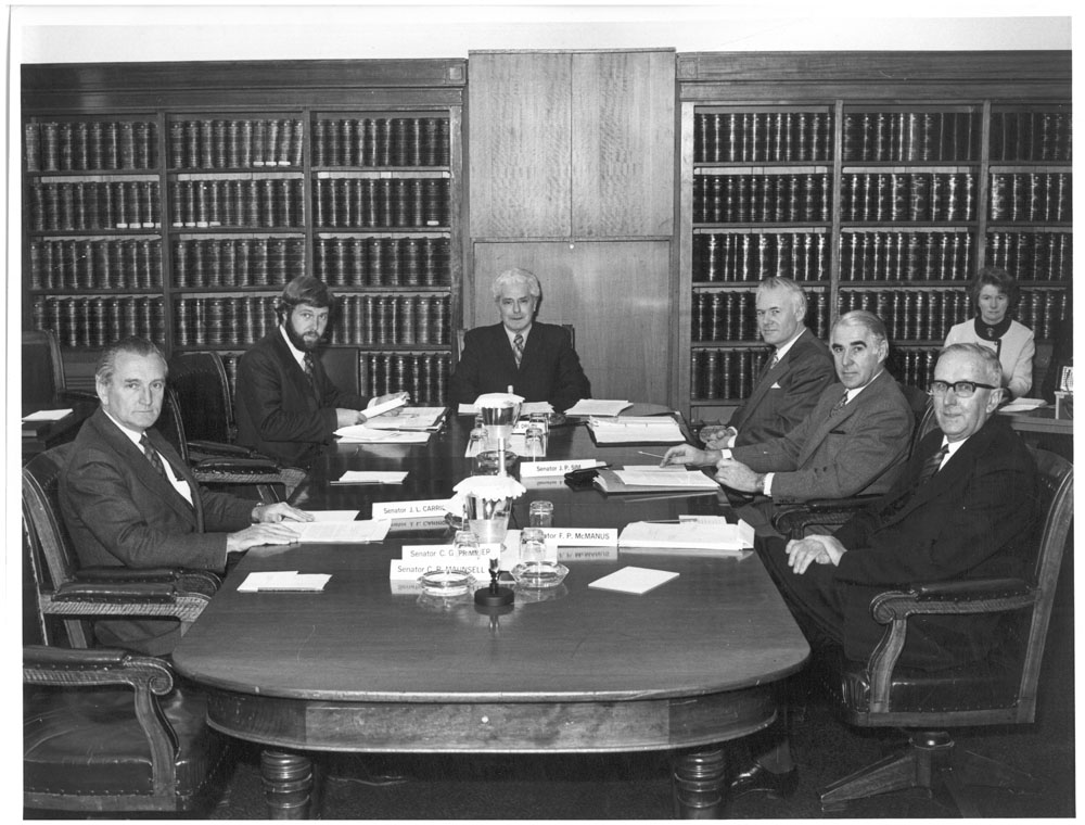 Standing Committee on Foreign Affairs and Defence, 1973. L-R: Senator John Carrick, unknown secretariat staff, Senator Arnold Drury [Chair], unknown secretariat staff, Senators Peter Sim and Frank McManus. NAA: A6180, 31/7/73/11.