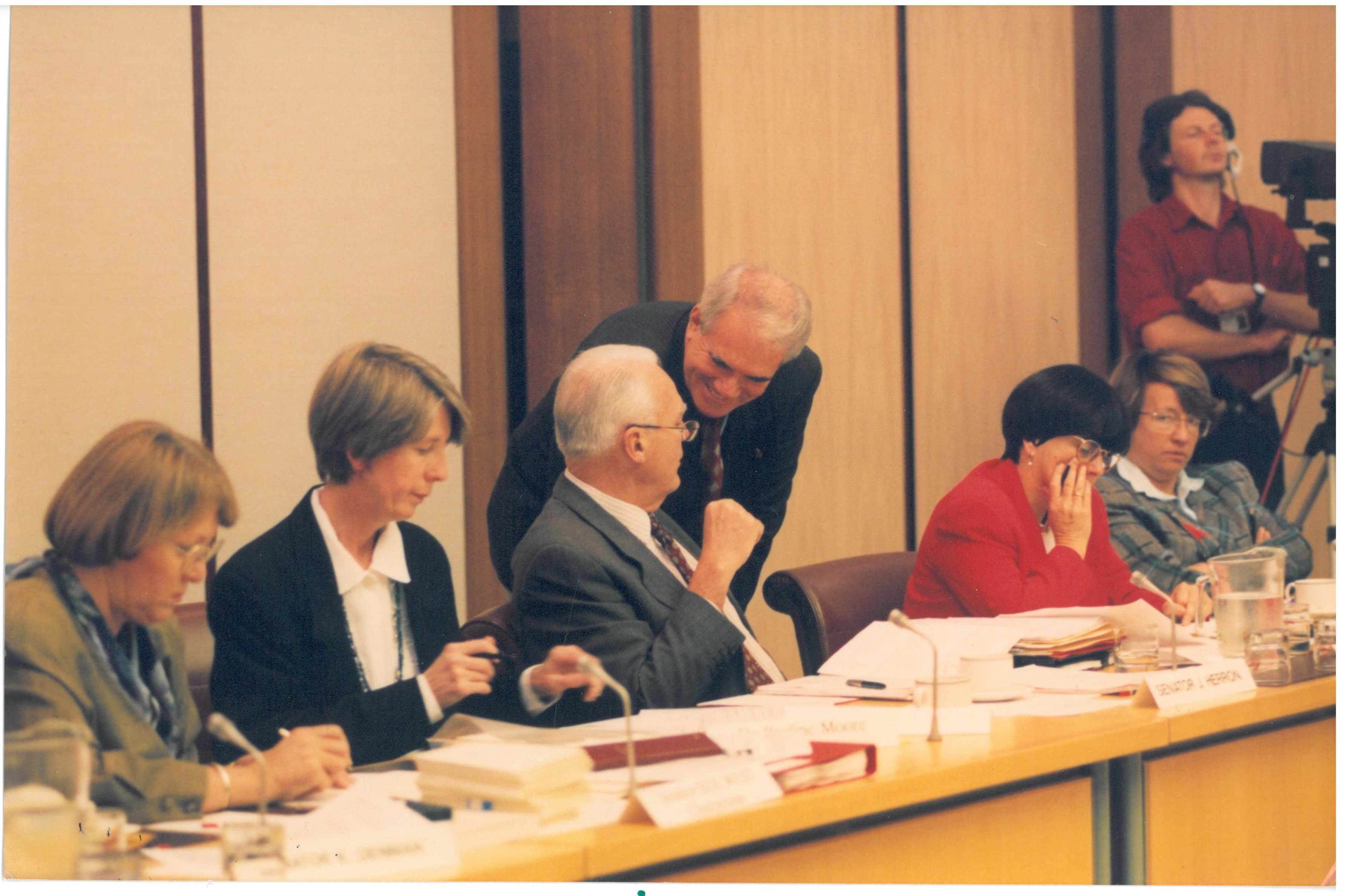 Members of the Senate Community Affairs Legislation Committee hearing evidence from witnesses at a public hearing of its inquiry into the Supported Accommodation Assistance Bill 1994 and the Supported Accommodation Assistance Amendment Bill 1994, 1 December 1994. Seated L-R: Senator Sue West [Chair], Dr Pauline Moore [Secretary], Senators John Herron, Grant Tambling, Kay Patterson and Meg Lees [Deputy Chair].