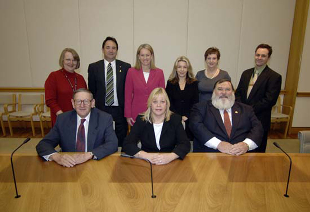 Members of the Senate and House of Representatives standing committees on Publications, 11 May 2006. Standing L-R: Vicki Bradley [Papers Manager], Senators Glenn Sterle, Fiona Nash, Dana Wortley and Helen Polley, and Jason Sherd [Secretary]. Seated L-R: Senator John Watson [Deputy Chair], Trish Draper MP [Chair] and Dick Adams MP. DPS Auspic.
