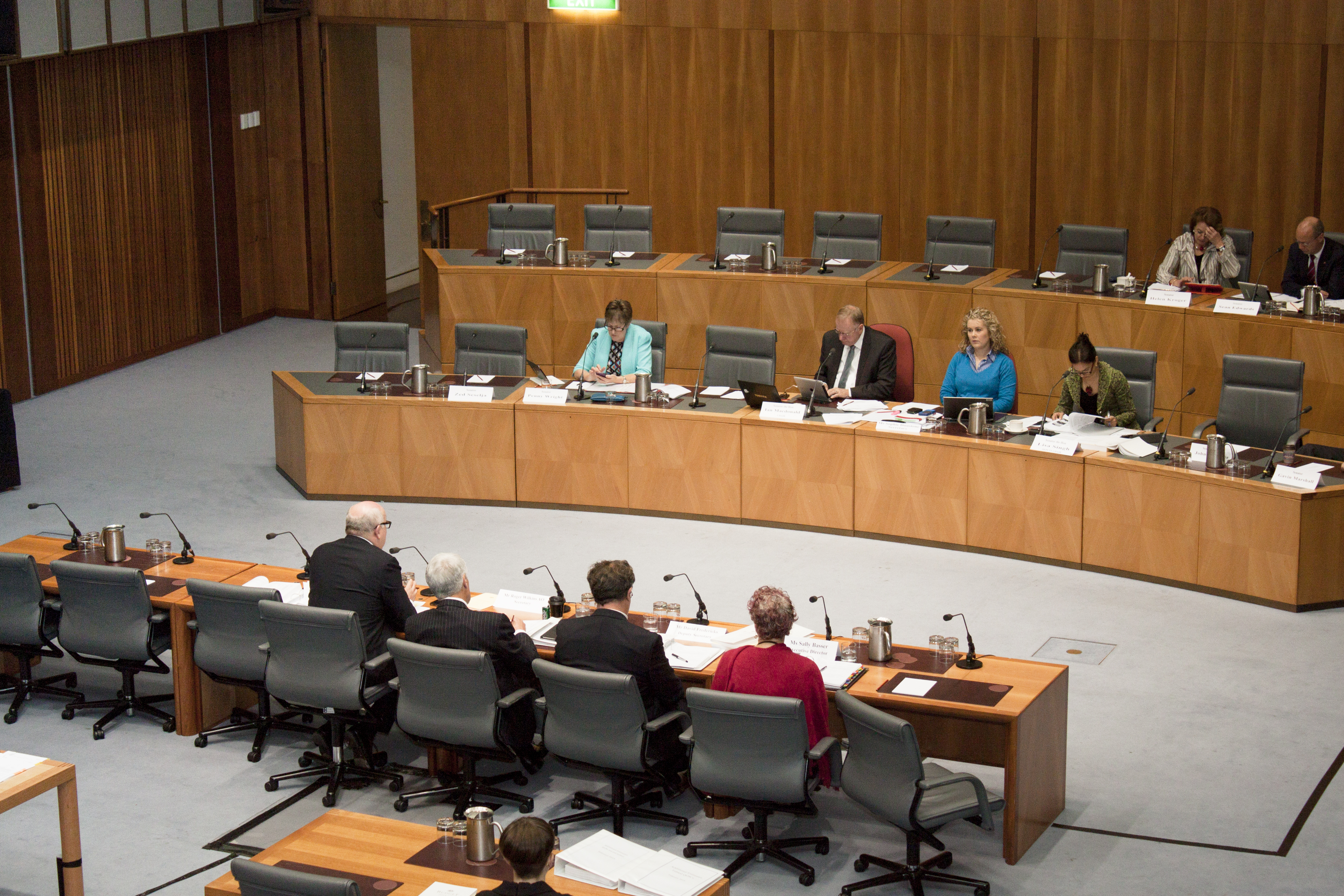 Committee members questioning Senator the Hon George Brandis, Attorney-General and Minister for the Arts, and departmental officers, 28 May 2014. Seated in top row L-R: Senators Helen Kroger and Sean Edwards. Seated in bottom row facing camera L-R: Senators Penny Wright and Ian Macdonald [Chair], Sophie Dunstone [Secretary] and Senator Lisa Singh [Deputy Chair].