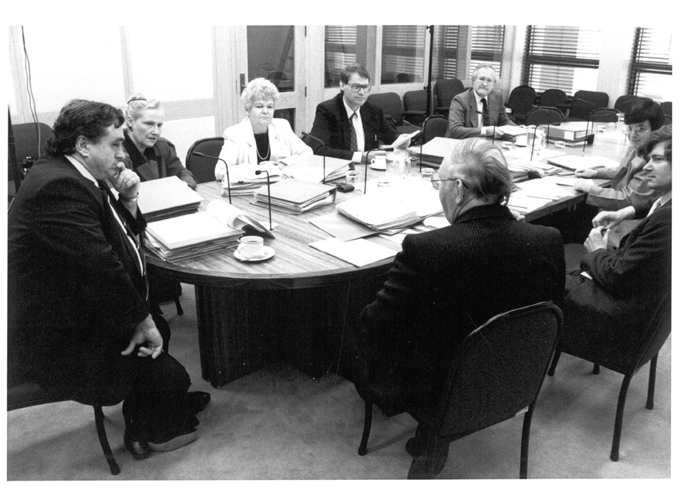 Standing Committee on Regulations and Ordinances in session, 1989. Clockwise around table from left: Senators Bob Collins [Chair], Bronwyn Bishop, Patricia Giles, John Faulkner, John Stone and Kay Patterson, David Creed [Secretary] and Professor Douglas Whalan [Legal Adviser]. Government Photographic Service.