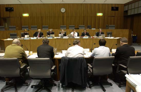 Foreign Affairs, Defence and Trade Legislation Committee questioning Senator the Hon Robert Hill, Minister for Defence, and officers from the Department of Defence at a budget estimates hearing, 1 June 2004. Seated facing camera L-R: Senators Marise Payne, Alan Ferguson and Sandy Macdonald, Saxon Patience [Acting Secretary], Senators Andrew Bartlett, Chris Evans and John Faulkner. DPS Auspic.