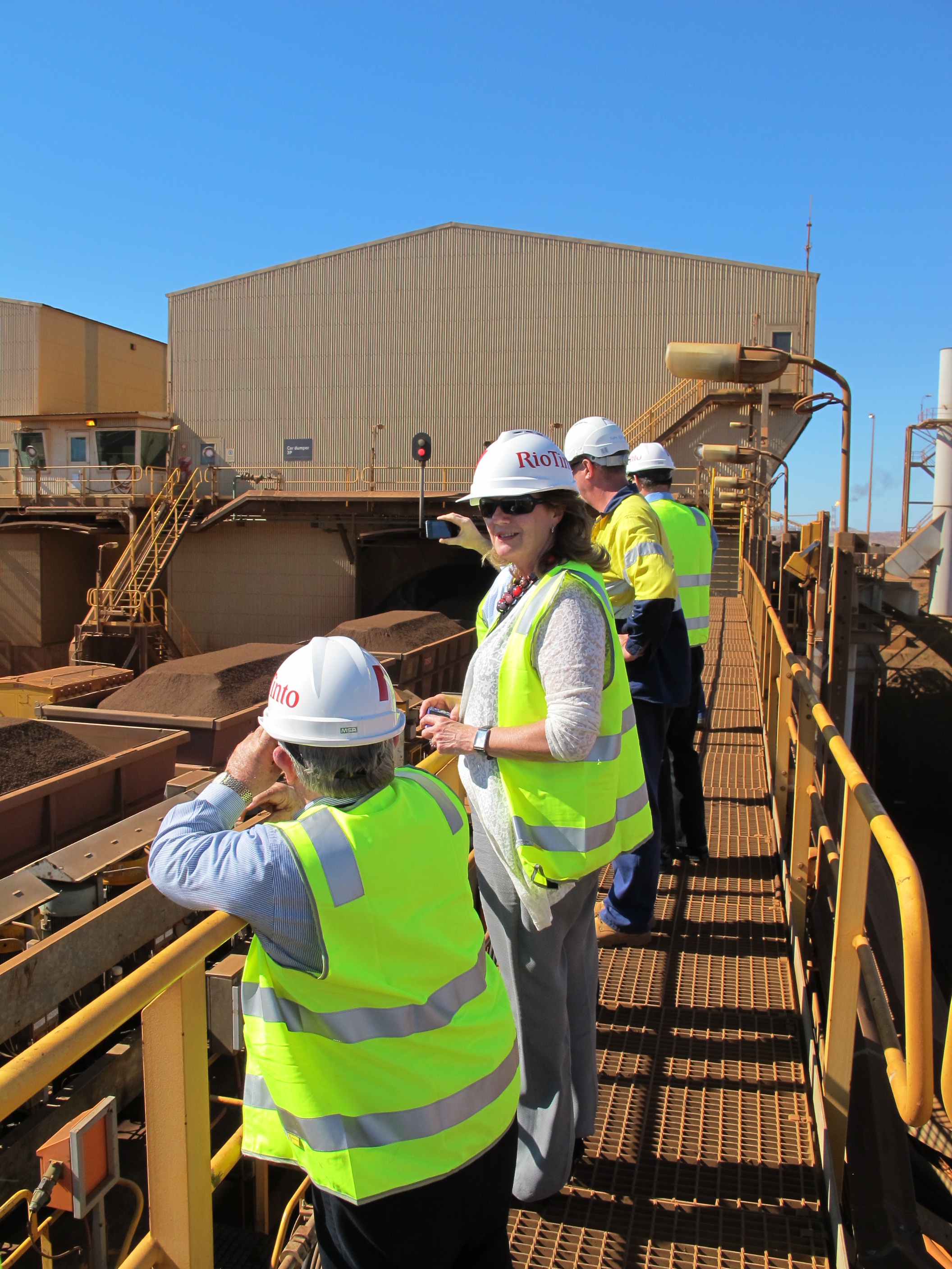 Committee members inspecting trains delivering iron ore extracted from mines in the Pilbara region to the Rio Tinto site at Dampier, 23 April 2013.