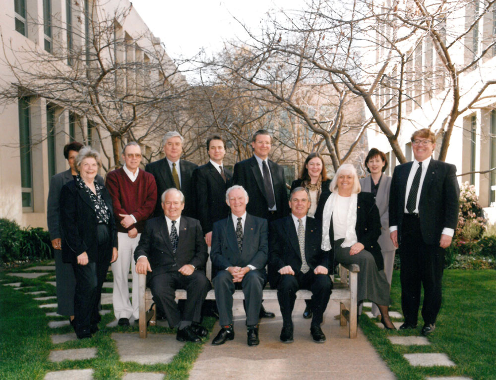 Members and staff of the Rural and Regional Affairs and Transport Legislation Committee, 1999. Standing from left: Rosalind McMahon [Executive Assistant], Jade Ricza [Executive Assistant], John O'Keefe [Senior Research Office], Senators Michael Forshaw, Julian McGauran and Kerry O'Brien, Robina Jaffray [Principal Research Officer], Trish Carling [Estimates/Research Officer], Andrew Snedden [Secretary]; Seated L-R: Senators Winston Crane, John Woodley, Paul Calvert and Jeannie Ferris.