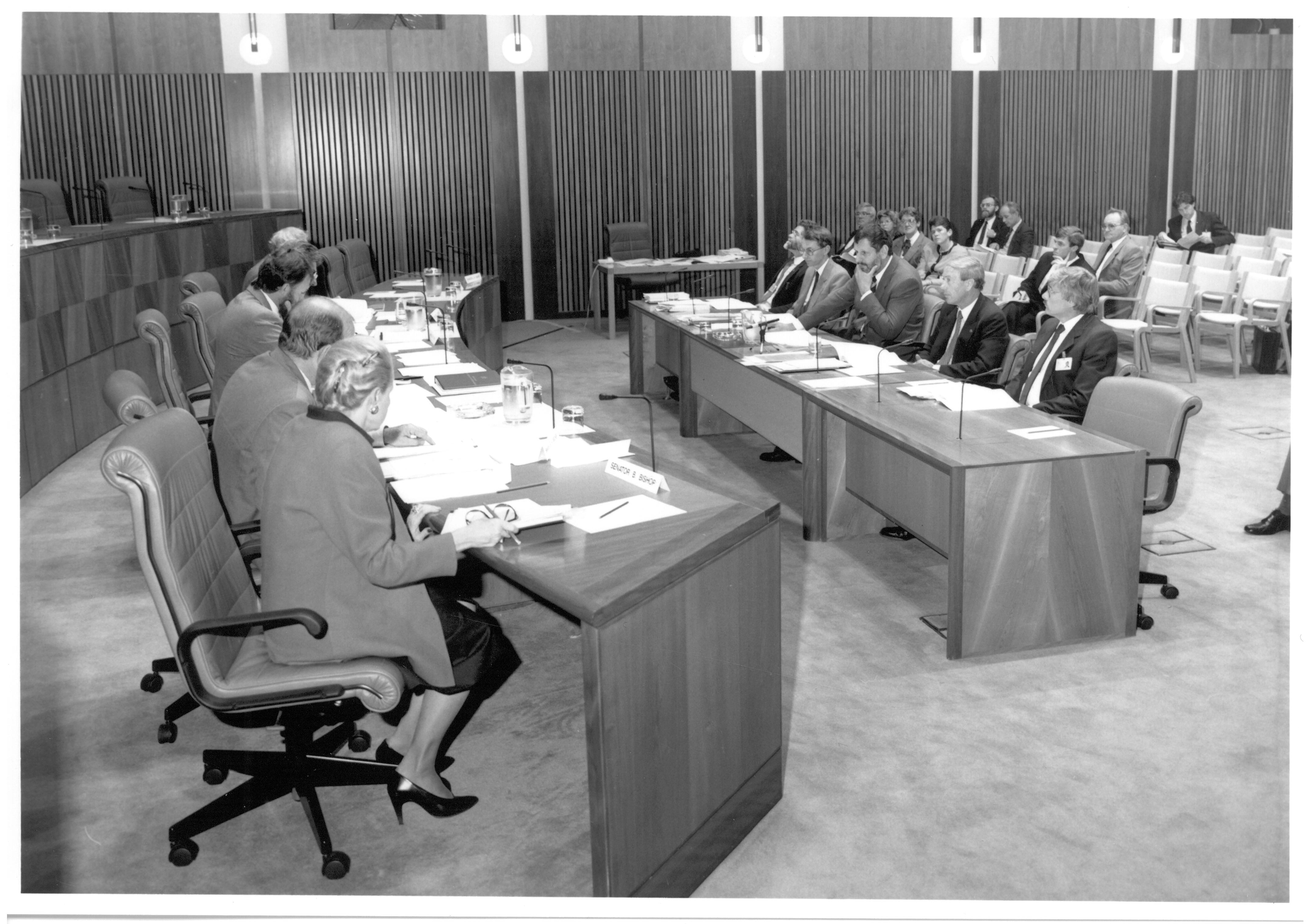 Estimates Committee A questioning staff of the Department of the Senate, 14 May 1990. Seated on left, closest to farthest: Senators Bronwyn Bishop and Brian Archer, Peter Keele [Secretary], Senators Bruce Childs [Chair] and Bryant Burns. Seated at witness table L-R: Witnesses Peter O'Keefe [Clerk Assistant (Committees)], Cleaver Elliott [Clerk Assistant (Procedure)], Harry Evans [Clerk of the Senate], Senator Kerry Sibraa [President of the Senate] and John Vander Wyk [Clerk Assistant (Management)].