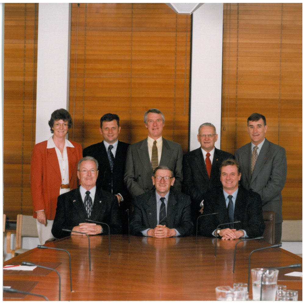 Members and staff of the Select Committee on Superannuation and Financial Services, 2002. Standing L-R: Sue Morton [Secretary], Senators John Cherry, Grant Chapman, Geoff Buckland and John Hogg. Seated L-R: Senators Ross Lightfoot, John Watson [Chair] and Nick Sherry [Deputy Chair].