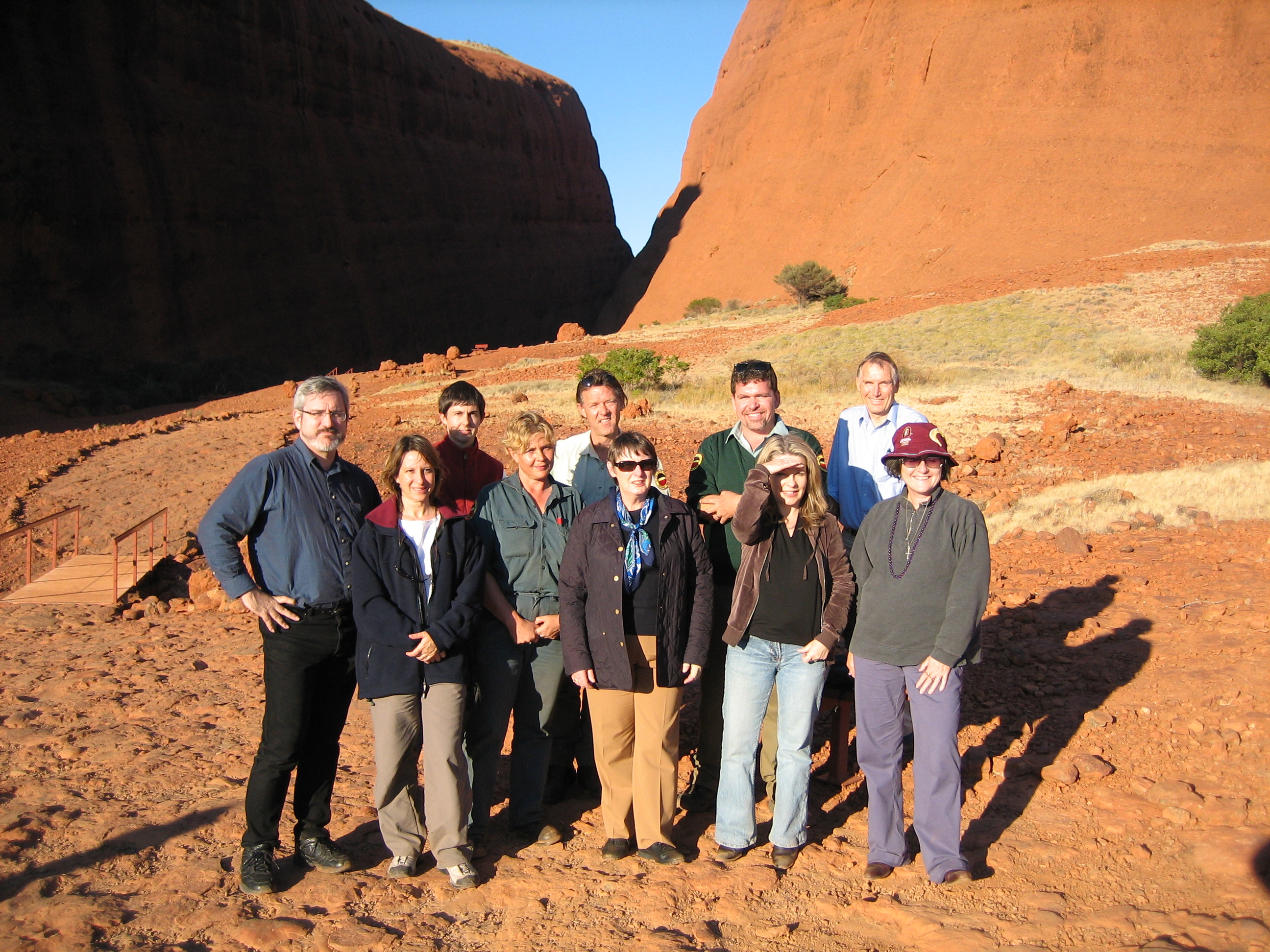 Committee members with Parks Australia staff during a site visit to Uluru-Kata Tjuta National Park as part of its inquiry into the funding and resources available to meet the objectives of Australia's national parks, other conservation reserves and marine protected areas, 27 June 2006. Back row L-R:  Senator Andrew Bartlett [Chair], Dr Ian Holland [Secretary] and three Parks Australia employees. Front row L-R: Dr Jacqueline Dewar [Acting Secretary], a Parks Australia employee, Senators Judith Adams [Deputy Chair], Dana Wortley and Claire Moore.