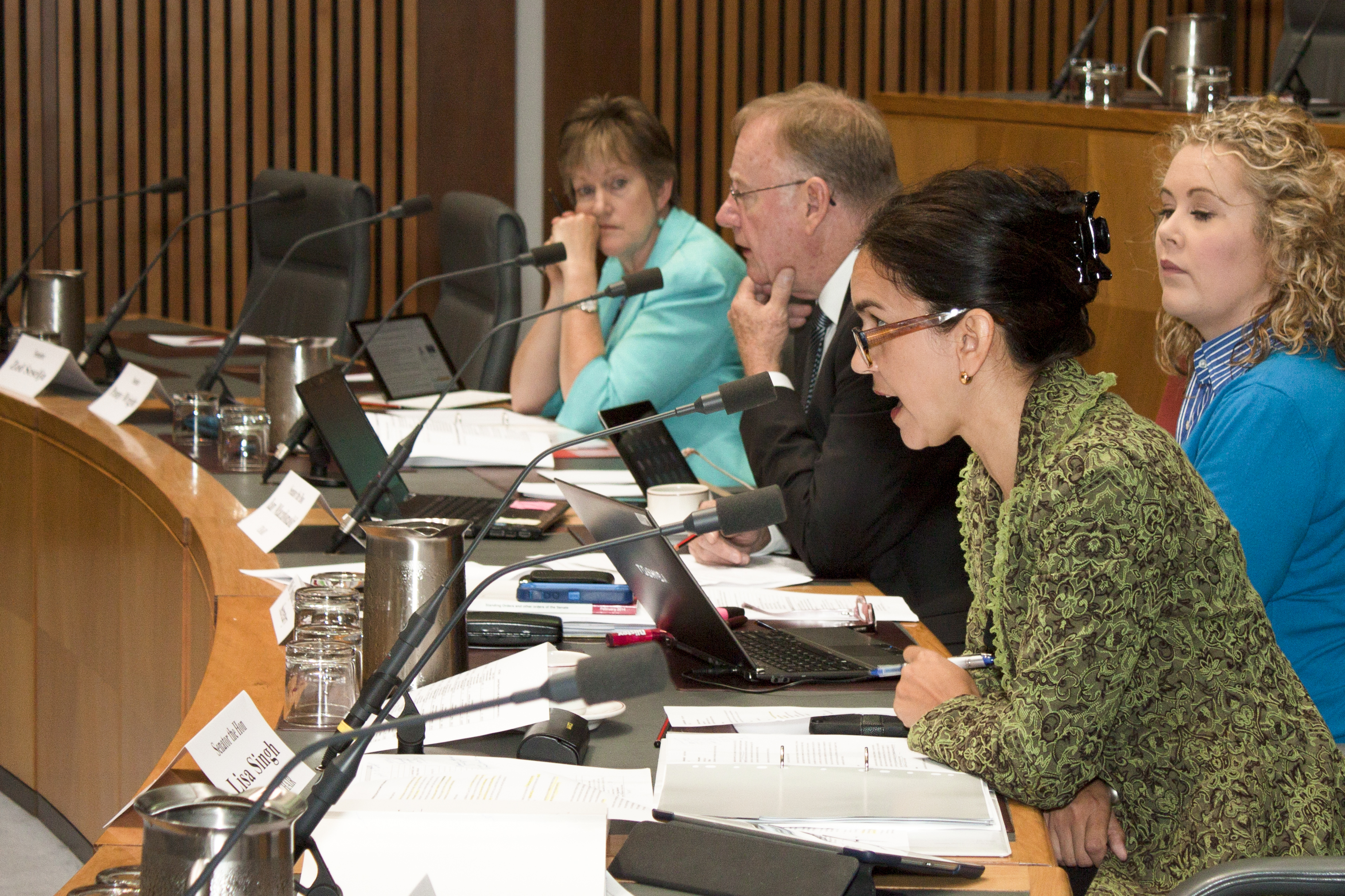 Budget estimates hearing, 28 May 2014. L-R: Senators Penny Wright, Ian Macdonald [Chair] and Lisa Singh [Deputy Chair], Sophie Dunstone [Secretary] (seated behind Senator Singh).