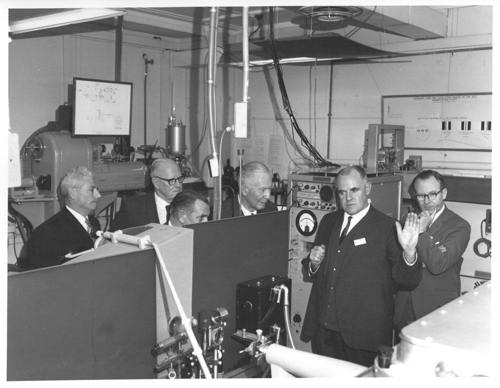 Fred Lehany, Chief of the Commonwealth Scientific and Industrial Research Organisation (CSIRO) Division of Applied Physics, accompanying members of the Select Committee on the Development of Canberrra on a site visit to the CSIRO National Standards Laboratory, Sydney, 1967. L-R: Senators Arnold Drury, Archie Benn, George Poyser and Keith Laught [Chair], Fred Lehany and a CSIRO researcher.