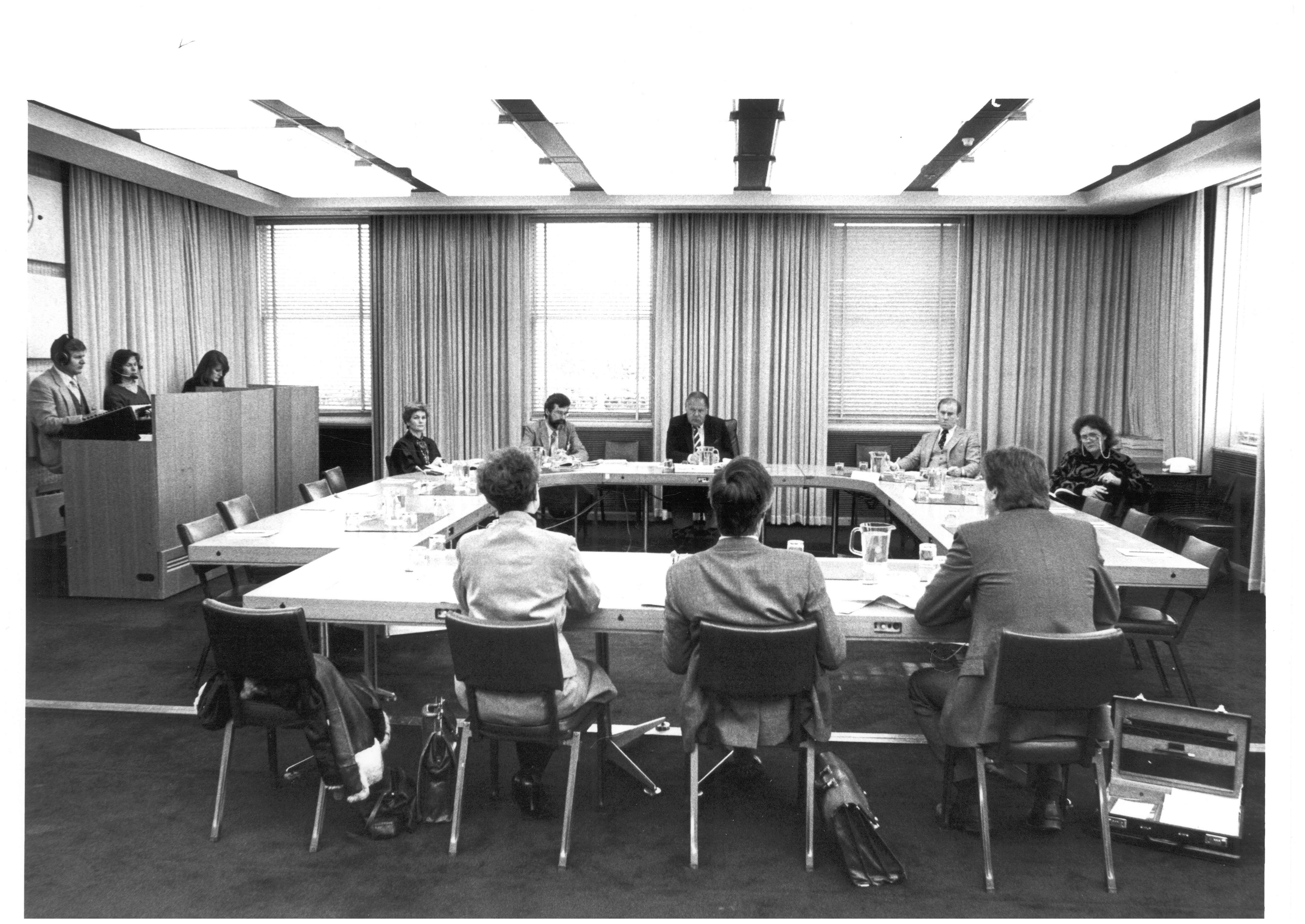 Standing Committee on Education and the Arts questioning officers from the Department of Education and Commonwealth Schools Commission at a public hearing of its inquiry into the education of gifted and talented children, 14 July 1986. After the 1987 election, the inquiry was referred to a select committee with the same membership for completion. Seated facing camera L-R: Senator Jocelyn Newman, Terry Brown [Secretary], Senators Mal Colston [Chair], Baden Teague and Margaret Reynolds.
