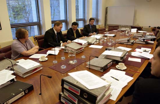 Standing Committee on Regulations and Ordinances in session ahead of the tabling of its 112th report, 23 June 2005. L-R: Janice Paull [Research Officer], James Warmenhoven [Secretary], Senator Tsebin Tchen [Chair] and Professor Stephen Bottomley [Legal Adviser]. DPS Auspic.