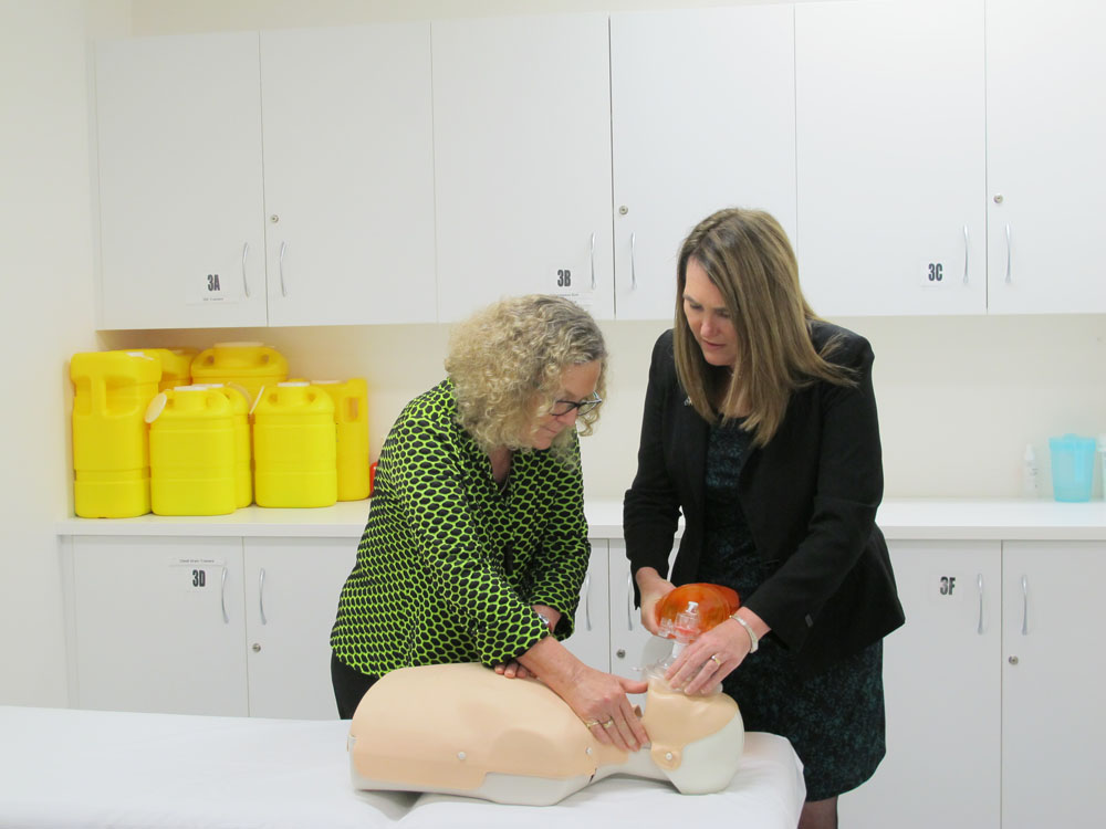 Senator Deborah O'Neill (right), chair of the Select Committee on Health, and committee member Senator Jan McLucas learning how the medical students from James Cook University conduct artificial respiration at the Townsville General Hospital, 21 August 2014.