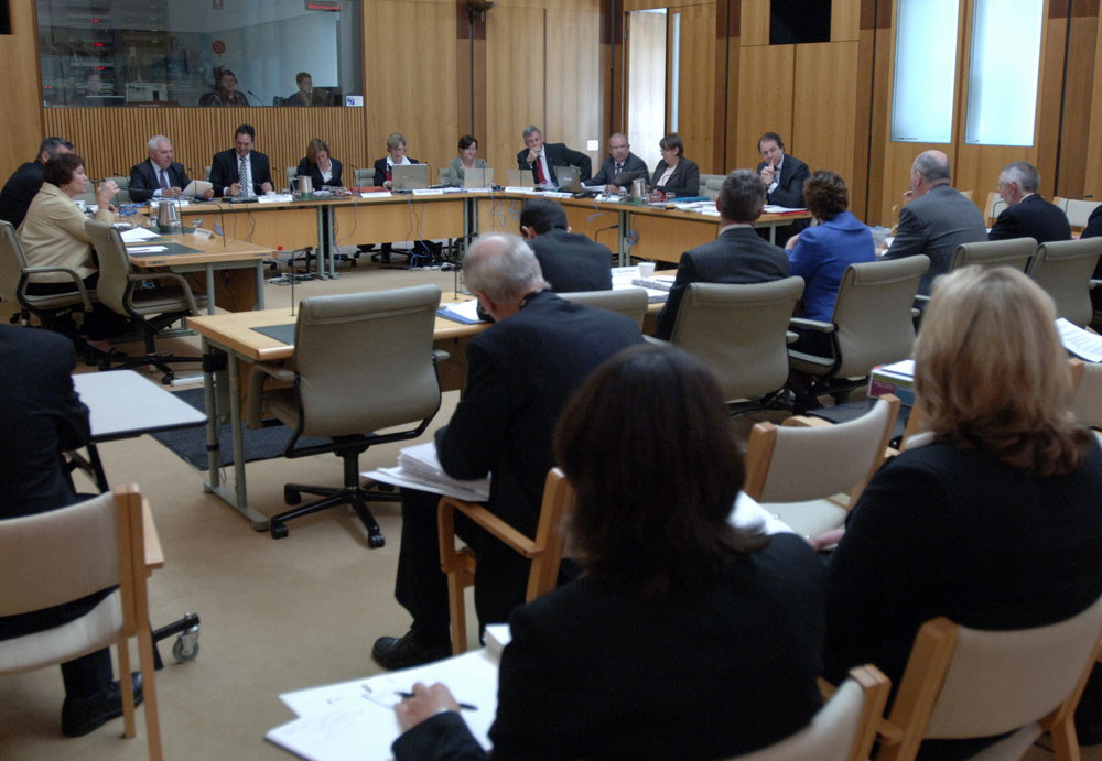 Members of the Standing Committee on Rural and Regional Affairs and Transport questioning Parliamentary Secretary Senator the Hon Ursula Stephens (representing the minister) and officers from the Department of Agriculture, Fisheries and Forestry at a supplementary budget estimates hearing, 20 October 2008. Seated facing witnesses clockwise from left: Senators Annette Hurley, Mark Furner (obscured), Steve Hutchins and Glenn Sterle [Chair], Jeanette Radcliffe [Secretary], Senators Christine Milne [Deputy Chair], Rachel Siewert, Richard Colbeck, John Williams, Judith Adams and Julian McGauran. DPS Auspic.