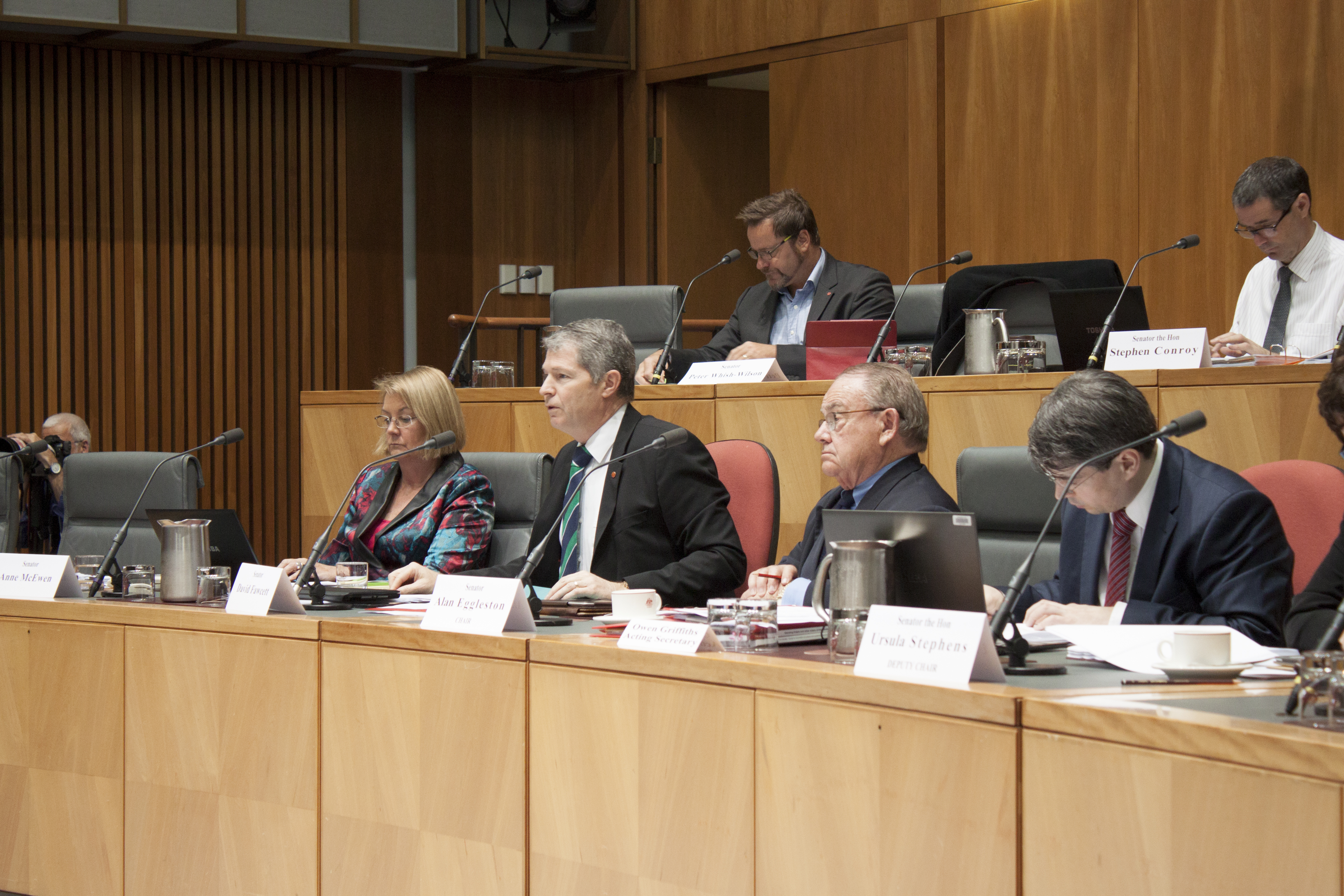 Foreign Affairs, Defence and Trade Legislation Committee budget estimates hearing, 2 June 2014. Top row L-R: Senators Peter Whish-Wilson and Stephen Conroy. Bottom row L-R: Senators Anne McEwen, David Fawcett and Alan Eggleston [Chair], and Owen Griffiths [Acting Secretary].