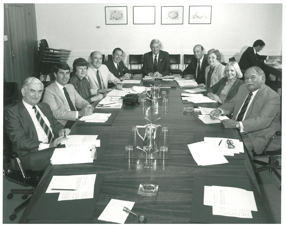 Members of the Senate House Committee attending a joint meeting with the House of Representatives House Committee, 1985. L-R: Allen Blanchard MP, Stephen Martin MP, Senators Olive Zakharov, Michael Townley and Douglas McClelland [President of the Senate], Harry Jenkins MP (Sr) [Chair; Speaker of the House of Representatives], unknown, Senator Florence Bjelke-Petersen, Kathy Sullivan MP and Robert Katter MP.